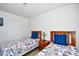 Bright bedroom with two twin beds featuring colorful floral patterns and wooden headboards, plus a bedside table and lamp at 6095 Catalina Dr. # 1614, North Myrtle Beach, SC 29582