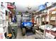 Organized garage featuring a golf cart, tools, storage shelves, and other equipment neatly arranged for convenience at 6095 Catalina Dr. # 1614, North Myrtle Beach, SC 29582