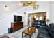 Comfortable living room with TV, hardwood floors, fan and cozy seating at 6095 Catalina Dr. # 1614, North Myrtle Beach, SC 29582
