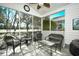 A screened porch featuring lovely wicker furniture provides a peaceful outdoor retreat at 6095 Catalina Dr. # 1614, North Myrtle Beach, SC 29582