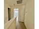 A carpeted hallway with neutral walls featuring a door to a bright room at 721 Painted Bunting Ct. # C, Murrells Inlet, SC 29576