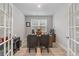 Bright home office featuring a wood desk, neutral walls, and French doors leading to other parts of the home at 729 Choctaw Dr., Conway, SC 29526