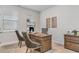 Home office with a wooden desk, wood flooring, and natural light streaming through the windows at 729 Choctaw Dr., Conway, SC 29526