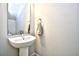 Bathroom featuring a pedestal sink, mirror and towel rack against light gray walls at 753 Moen Pl. # B, Myrtle Beach, SC 29577