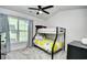 Cozy bedroom featuring a bunk bed, a ceiling fan, and natural light from a window at 753 Moen Pl. # B, Myrtle Beach, SC 29577