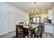 Bright dining area featuring a modern chandelier, dining table with hardwood top and six leather dining chairs at 753 Moen Pl. # B, Myrtle Beach, SC 29577