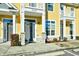 Close up of townhouse exteriors featuring neutral-colored doors, well kept landscaping, and stone pillar accents at 753 Moen Pl. # B, Myrtle Beach, SC 29577