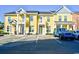 Shot of bright yellow townhouse-style condos in the complex with private parking in front of the units at 753 Moen Pl. # B, Myrtle Beach, SC 29577