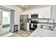 View of kitchen area with granite countertops, stainless steel appliances, white cabinetry and hardwood floors at 753 Moen Pl. # B, Myrtle Beach, SC 29577