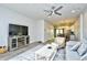 A view of the living room with hardwood floors, modern ceiling fan, and comfortable, neutral-colored furnishings at 753 Moen Pl. # B, Myrtle Beach, SC 29577