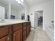 Well-lit bathroom featuring a double sink vanity and a separate bathtub and walk-in closet at 80-2 Knight Circle # 2, Pawleys Island, SC 29585