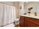 Bathroom with wooden cabinets, a shower with curtain, and cat decor at 80-2 Knight Circle # 2, Pawleys Island, SC 29585