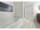 Clean bathroom featuring a soaking tub with tiled floors and a nearby vanity at 80-2 Knight Circle # 2, Pawleys Island, SC 29585