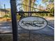 Kings Creek community sign with wrought iron detail, street view, and landscaping at 80-2 Knight Circle # 2, Pawleys Island, SC 29585