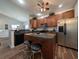 Well-lit kitchen featuring wood cabinetry, stainless steel appliances and an island with barstools at 80-2 Knight Circle # 2, Pawleys Island, SC 29585