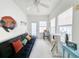 Bright living space featuring a black futon, colorful pillows, and a modern cat tree at 80-2 Knight Circle # 2, Pawleys Island, SC 29585