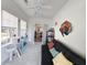 Bright living room with a black futon, a modern cat tree, and double doors to another room at 80-2 Knight Circle # 2, Pawleys Island, SC 29585