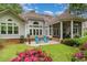 Beautiful backyard featuring a screen porch, patio, lush landscaping, and outdoor seating at 921 Heshbon Dr., North Myrtle Beach, SC 29582