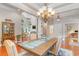 Elegant dining room with wood floors, statement chandelier, and views into the living room at 921 Heshbon Dr., North Myrtle Beach, SC 29582