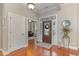 Welcoming foyer with hardwood floors, a decorative front door with glass, and a view to the living spaces beyond at 921 Heshbon Dr., North Myrtle Beach, SC 29582