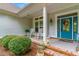 Charming front porch with rocking chairs, blue door, manicured shrubs and brick accents at 921 Heshbon Dr., North Myrtle Beach, SC 29582