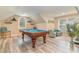 Bright game room featuring a pool table and accent seating with hard wood floors and natural light at 921 Heshbon Dr., North Myrtle Beach, SC 29582