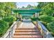 Inviting Tennis Center entrance surrounded by lush landscaping and brick walkways at 921 Heshbon Dr., North Myrtle Beach, SC 29582