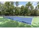 Well-maintained tennis courts with green and blue surfaces, surrounded by mature trees at 921 Heshbon Dr., North Myrtle Beach, SC 29582