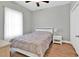 Clean bedroom with a neatly made queen-sized bed and white nightstand, lit by soft lighting at 940 Jackline Place # 202, Murrells Inlet, SC 29576