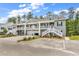 Attractive townhouse complex boasting elevated entrances, garages, and well-maintained landscaping at 940 Jackline Place # 202, Murrells Inlet, SC 29576