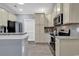 Functional kitchen with granite countertops, stainless steel appliances, and tiled backsplash at 940 Jackline Place # 202, Murrells Inlet, SC 29576