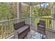 Relaxing screened porch featuring comfortable seating and views of the surrounding wooded landscape at 940 Jackline Place # 202, Murrells Inlet, SC 29576