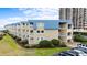 Beachfront condo with blue trim, multiple balconies, and manicured landscaping at 9660 Shore Dr. # 117, Myrtle Beach, SC 29572