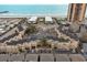 Lovely aerial view of condos featuring a pool, tennis court, and parking, with a beautiful ocean view at 9661 Shore Dr. # A-21, Myrtle Beach, SC 29572