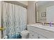 Bathroom featuring a toilet, sink with vanity, and a shower with a blue printed curtain at 9661 Shore Dr. # A-21, Myrtle Beach, SC 29572