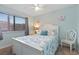 Bright bedroom with a queen-sized bed, ceiling fan, and window for natural light at 9661 Shore Dr. # A-21, Myrtle Beach, SC 29572