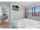 Light and airy bedroom featuring a queen-sized bed, tv and a view into the kitchen at 9661 Shore Dr. # A-21, Myrtle Beach, SC 29572