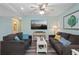 Bright living room with two couches, large screen tv, and neutral decor at 9661 Shore Dr. # A-21, Myrtle Beach, SC 29572