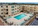 Aerial view of community pool surrounded by lounge chairs and tables at condo complex at 9661 Shore Dr. # A-21, Myrtle Beach, SC 29572