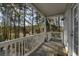 Cozy covered balcony features wood floors and peaceful wooded views at 98 Wallys Way # 1, Pawleys Island, SC 29585