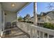 Outdoor balcony with chairs offers a relaxing view of the neighboring coastal-style homes at 98 Wallys Way # 1, Pawleys Island, SC 29585