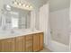 Well-lit bathroom featuring a double sink vanity and shower-tub combination at 98 Wallys Way # 1, Pawleys Island, SC 29585