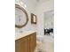 Bathroom features a wooden cabinet vanity, round mirror, and tile flooring at 98 Wallys Way # 1, Pawleys Island, SC 29585