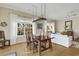 Dining room features a custom light fixture and large windows overlooking the yard at 98 Wallys Way # 1, Pawleys Island, SC 29585