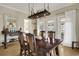 Elegant dining room features wood table, decorative light fixture, and access to outdoor space at 98 Wallys Way # 1, Pawleys Island, SC 29585