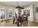 Dining room features a large wood table and access to the deck at 98 Wallys Way # 1, Pawleys Island, SC 29585