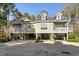 Exterior showing the property's elevated structure, and stilt design with generous ground-level space at 98 Wallys Way # 1, Pawleys Island, SC 29585