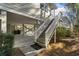 Exterior of home showcasing ground level stilts and staircase leading to the main living area at 98 Wallys Way # 1, Pawleys Island, SC 29585