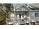 Cozy front porch featuring white railings, French doors, and a decorative wreath at 98 Wallys Way # 1, Pawleys Island, SC 29585