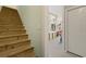 Wooden staircase with white trim and a view into another room at 98 Wallys Way # 1, Pawleys Island, SC 29585